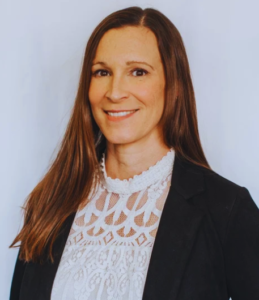 A woman in white shirt and black jacket.